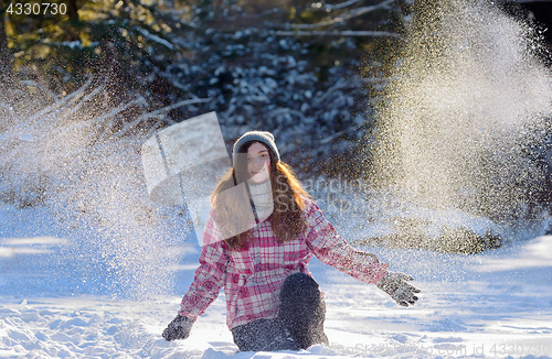 Image of teen girl playing in snow 