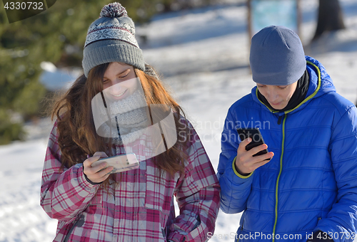 Image of Kids with Smartphone in winter forest