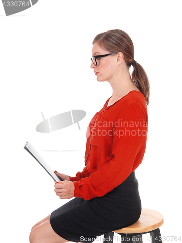 Image of Business woman with glasses and folder.