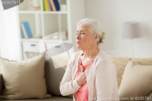 Image of senior woman suffering from heartache at home