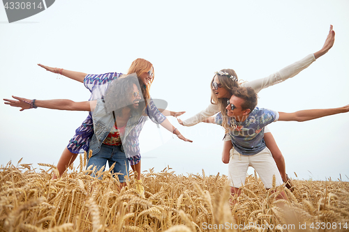 Image of happy hippie friends having fun on cereal field