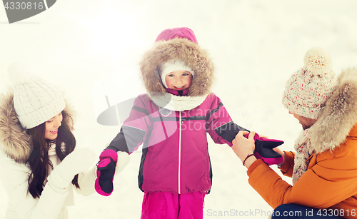 Image of happy family with child in winter clothes outdoors