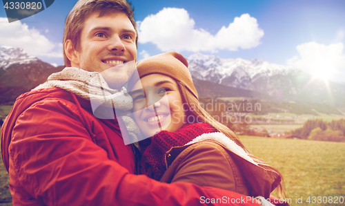Image of happy young couple hugging over alps mountains