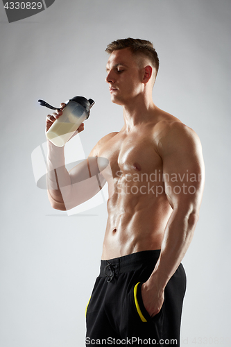 Image of young man or bodybuilder with protein shake bottle