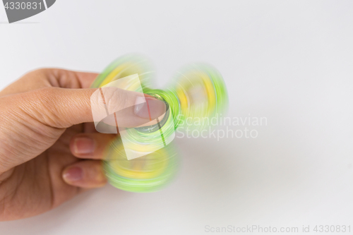 Image of close up of hand playing with fidget spinner