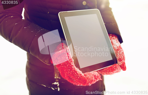 Image of close up of woman with tablet pc in winter