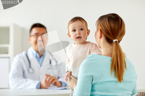 Image of happy woman with baby and doctor at clinic