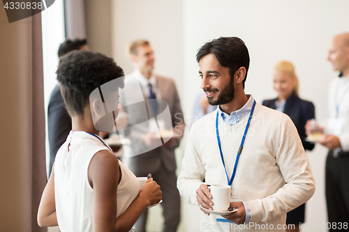 Image of business people with conference badges and coffee