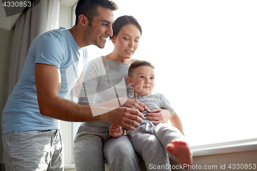 Image of happy family at window