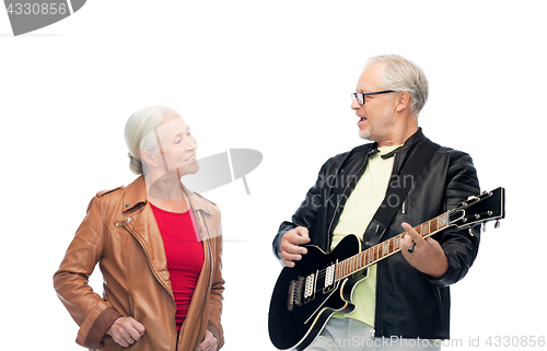 Image of happy senior couple with electric guitar