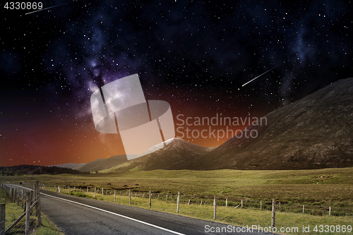 Image of night landscape of road and mountains over space