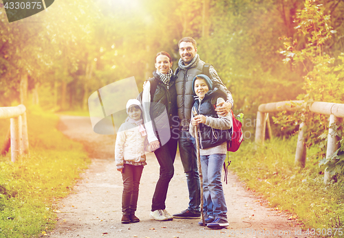 Image of happy family with backpacks hiking