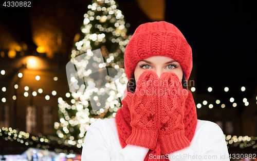 Image of young woman in winter clothes over christmas tree