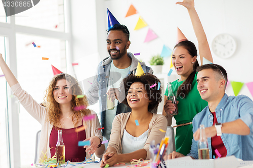 Image of happy team with confetti at office birthday party