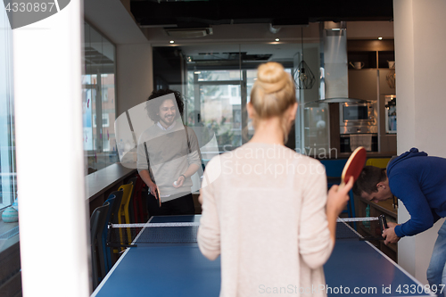 Image of startup business team playing ping pong tennis