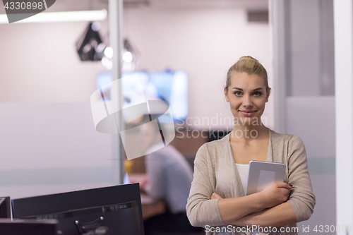 Image of Business Woman Using Digital Tablet in front of startup Office