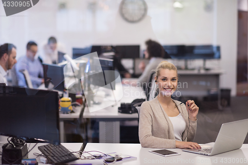Image of businesswoman using a laptop in startup office
