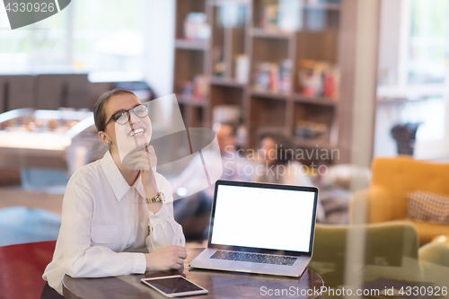 Image of businesswoman using a laptop in startup office