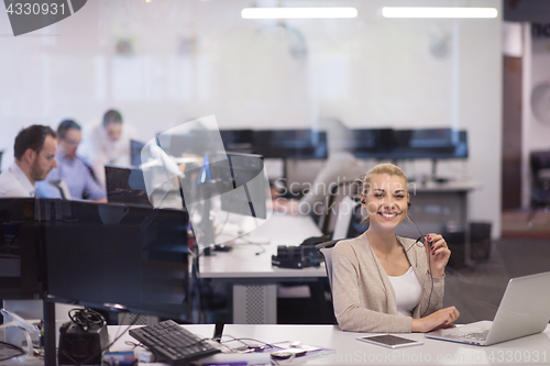 Image of businesswoman using a laptop in startup office