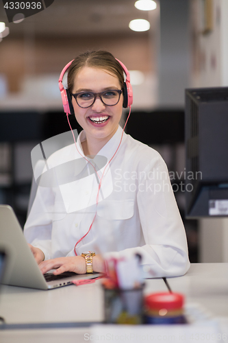 Image of businesswoman using a laptop in startup office