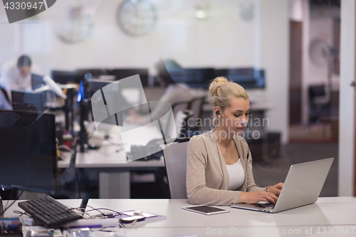 Image of businesswoman using a laptop in startup office