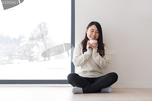 Image of asian woman enjoying morning coffee