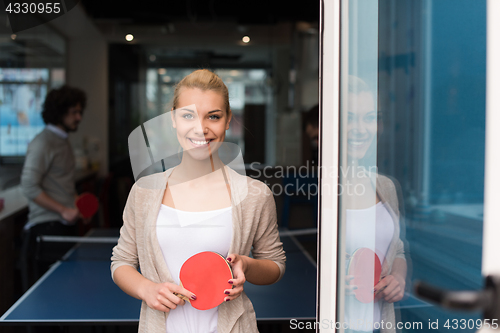 Image of startup business team playing ping pong tennis