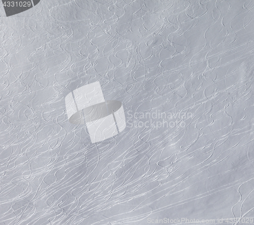 Image of Off-piste slope with traces of skis and snowboarding.