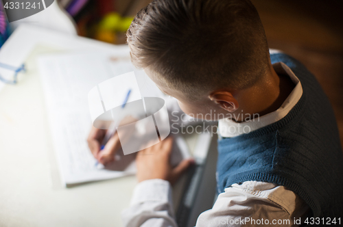 Image of pupil boy does his homework