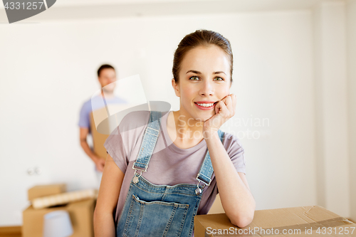 Image of happy couple with boxes moving to new home