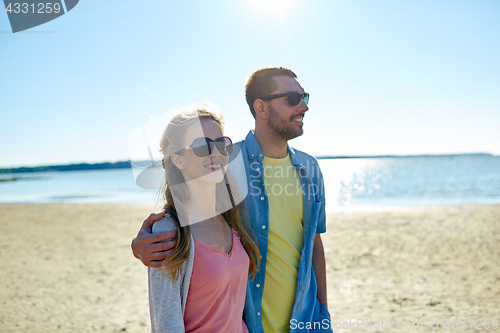 Image of happy couple hugging on summer beach