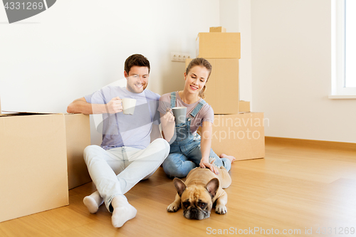 Image of happy couple with boxes and dog moving to new home
