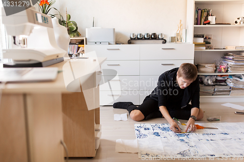 Image of fashion designer making dress at sewing studio