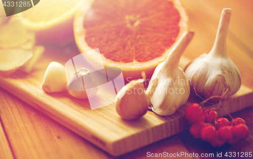 Image of citrus, ginger, garlic and rowanberry on wood