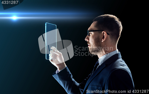 Image of businessman working with transparent tablet pc