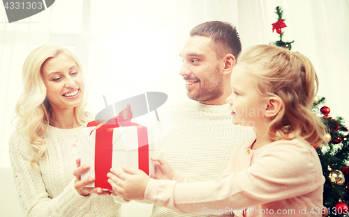 Image of happy family at home with christmas gift box