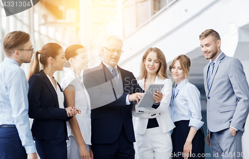 Image of business people with tablet pc computer at office