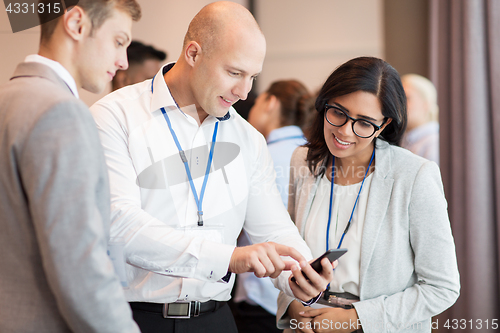 Image of couple with smartphone at business conference