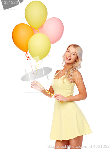 Image of happy woman in dress with helium air balloons