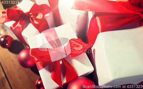 Image of close up of gift boxes and red christmas balls