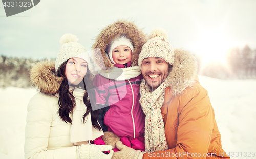 Image of happy family with child in winter clothes outdoors