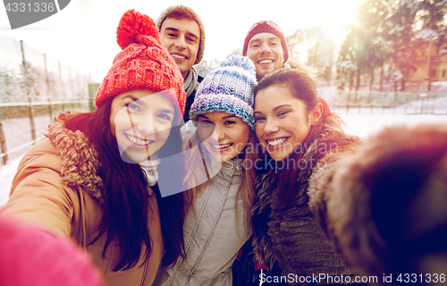 Image of happy friends taking selfie with smartphone