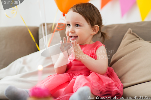 Image of happy baby girl on birthday party at home