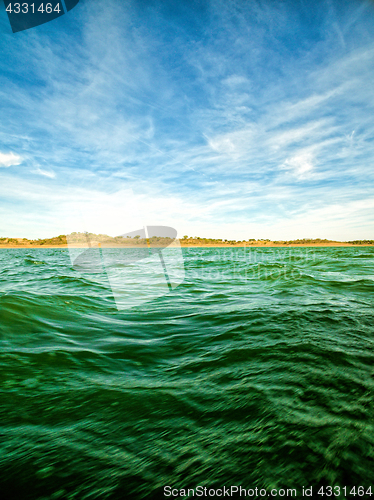 Image of Green Ocean Waves and Blue Sky with Clouds