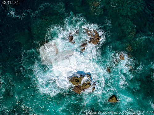 Image of Aerial View of Waves Breaking on Rock