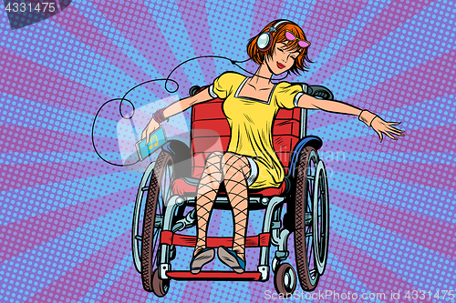 Image of Modern joyful teen girl disabled in a wheelchair, listening to m