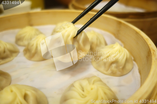 Image of Xiao Long Bao with chopsticks Streamed Pork Dumplings Taiwan foo