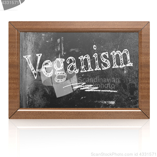 Image of Veganism text written on blackboard