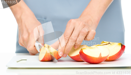 Image of Cook is chopping apple