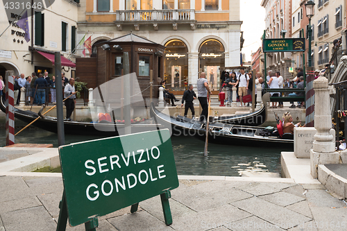 Image of People entering the typical gondolas of Venice, Italy